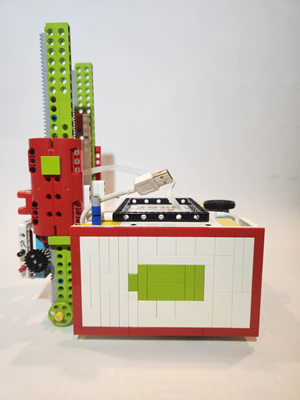 Students programming a robot at a table